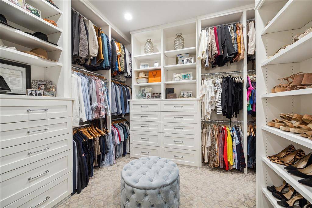 Large primary closet with thoughtful design to maximize space and storage. Closet curves around to right for additional space- not pictured.