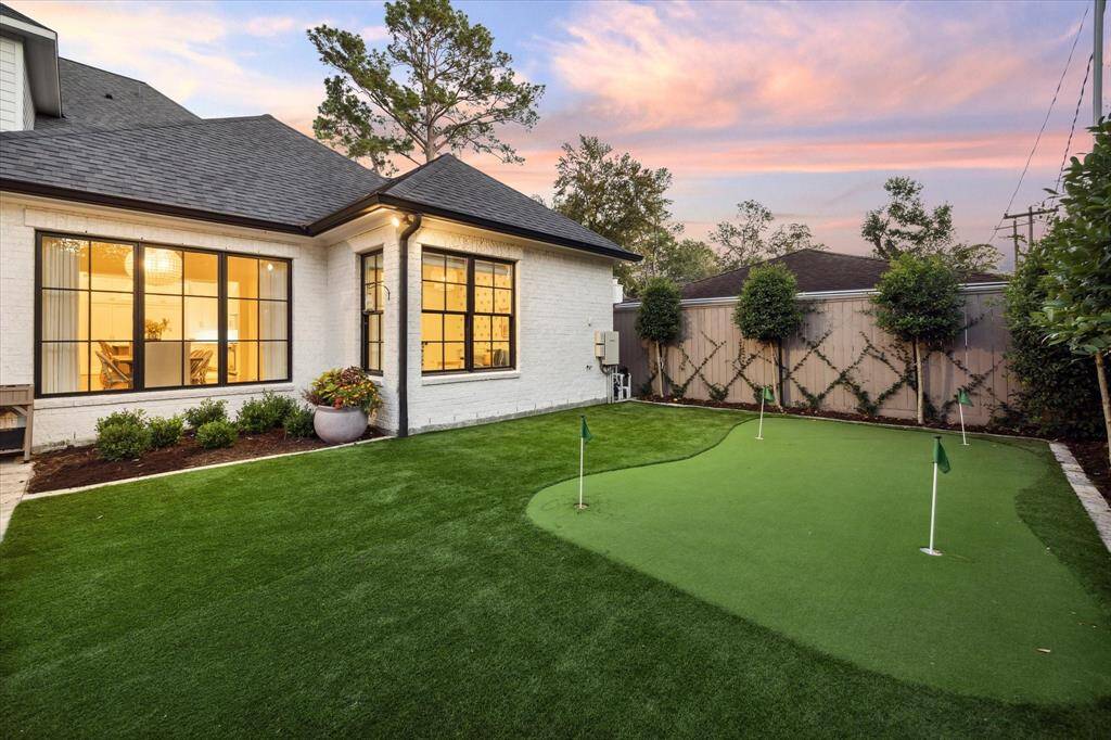 Side yard fully turfed with 4 hole putting green. Makes for ideal and easy maintenance.