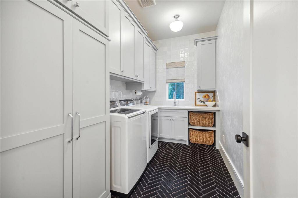 Laundry room near mudroom and garage area. Beautiful and very functional with ample storage.