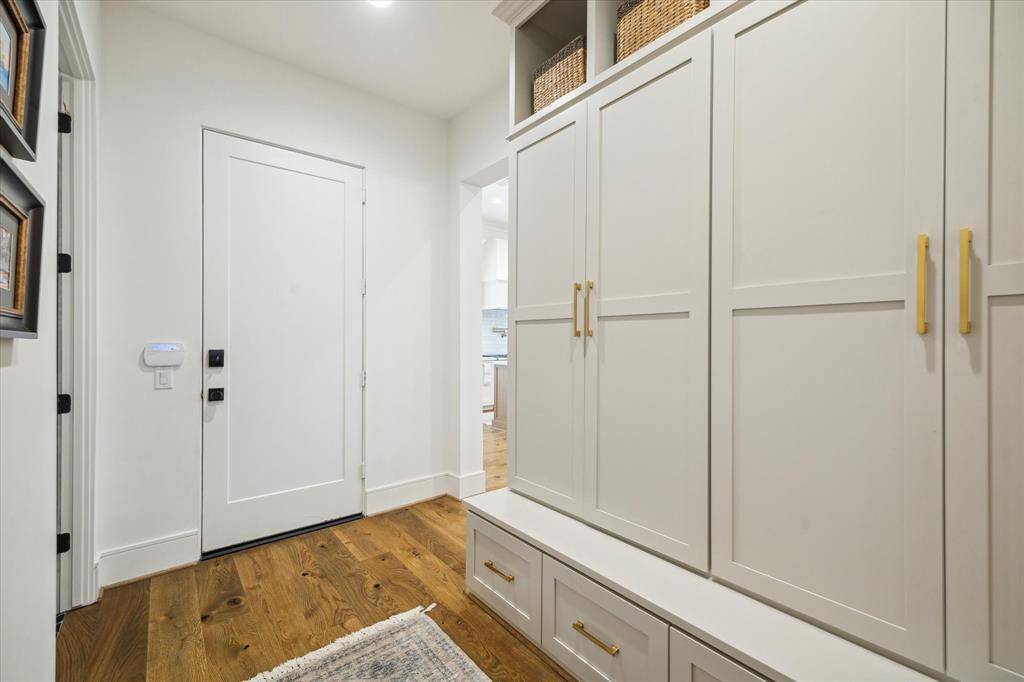 Mudroom with oversized lockers. Opens from garage and just off kitchen, makes for a very functional use of space.