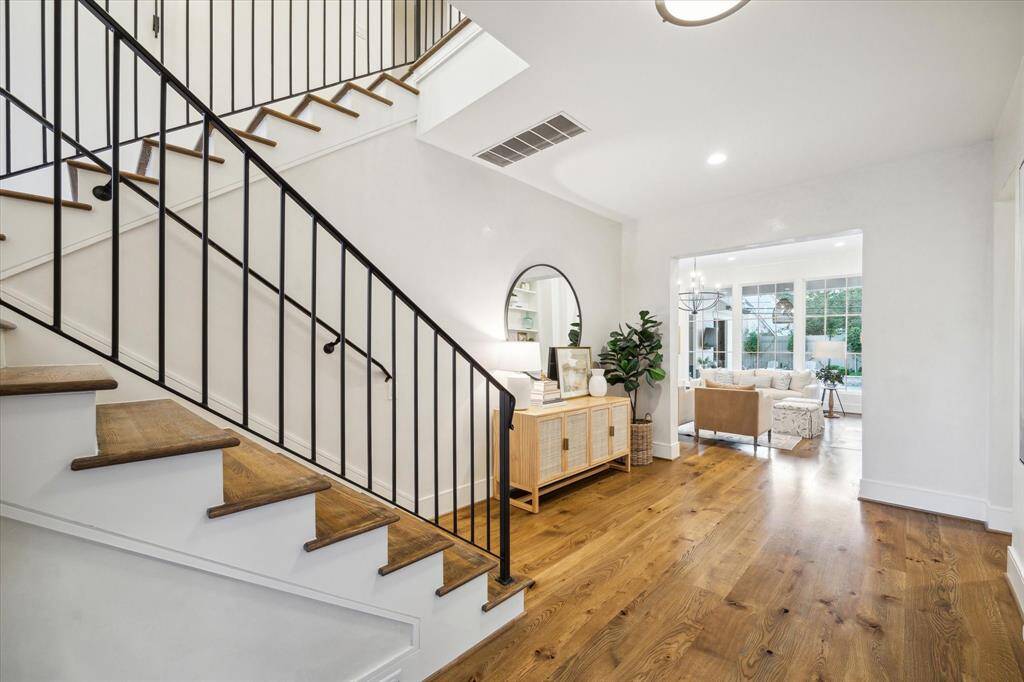 Entryway with views of family room and stairs