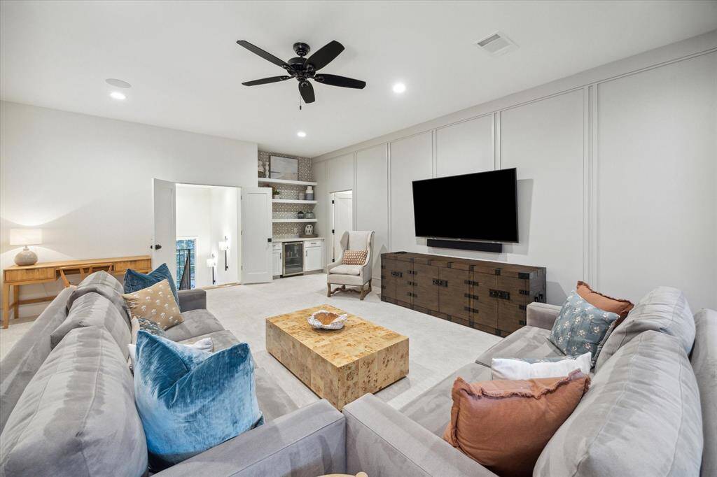 Game room with dry bar area shown. Smaller door shown leads to extra storage and exercise room.