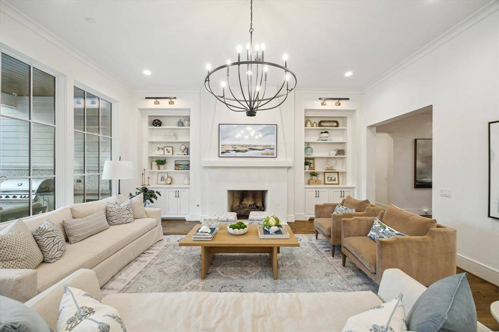 Family room anchored by Isokern fireplace with venetian plaster surround and flanked with custom built-ins.