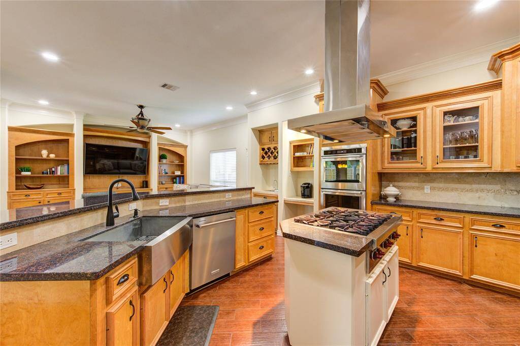 Alternate view showing some of the glass front cabinets. In addition to the recent stainless farm sink & disposal, the cabinets were reconfigured to add the dishwasher. Convenient pot and pan drawers, coffee station and built-in wine rack with 2nd sink.