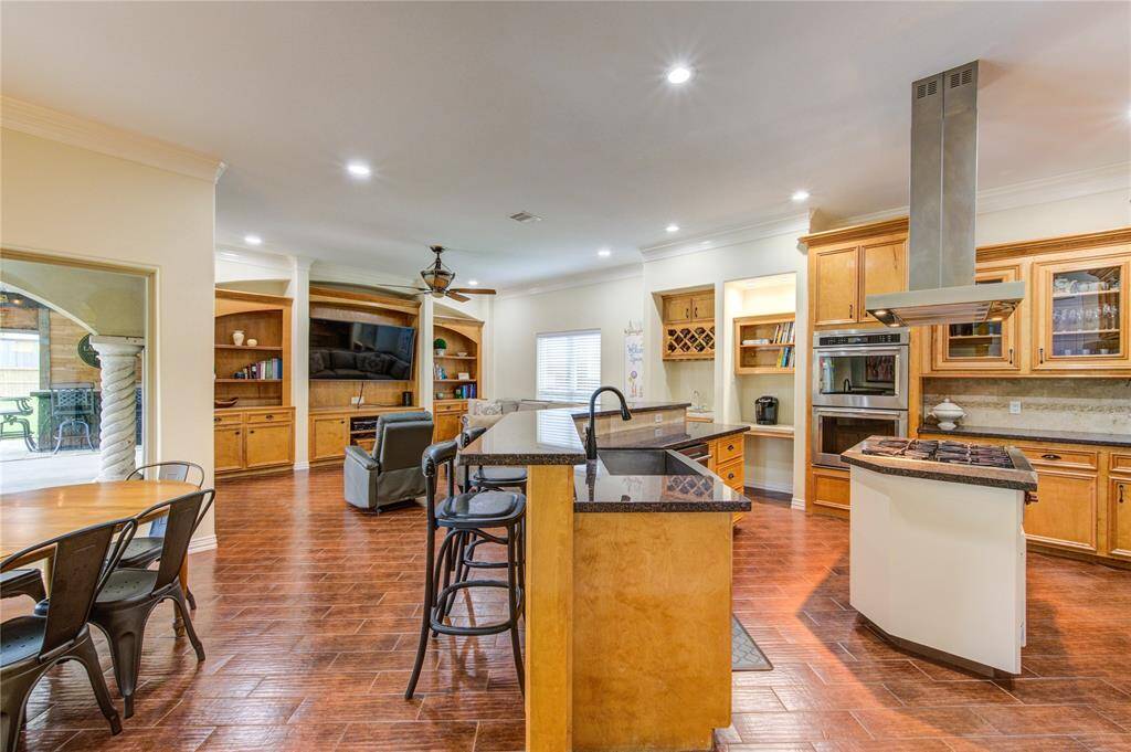 Kitchen is open to breakfast room and den/living area. There are full views of the veranda/pool area from every angle.