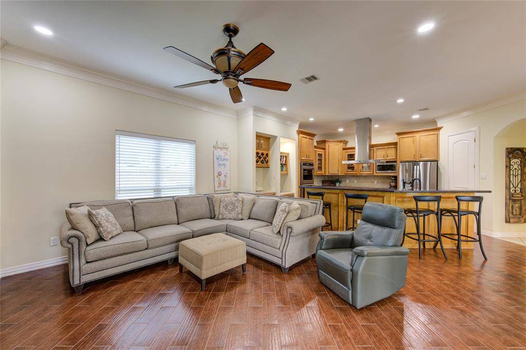 Den with vinyl plank flooring and addition of recessed lighting creates the perfect spot for family game nights. This space is open to kitchen, breakfast area allowing overflow when entertaining.