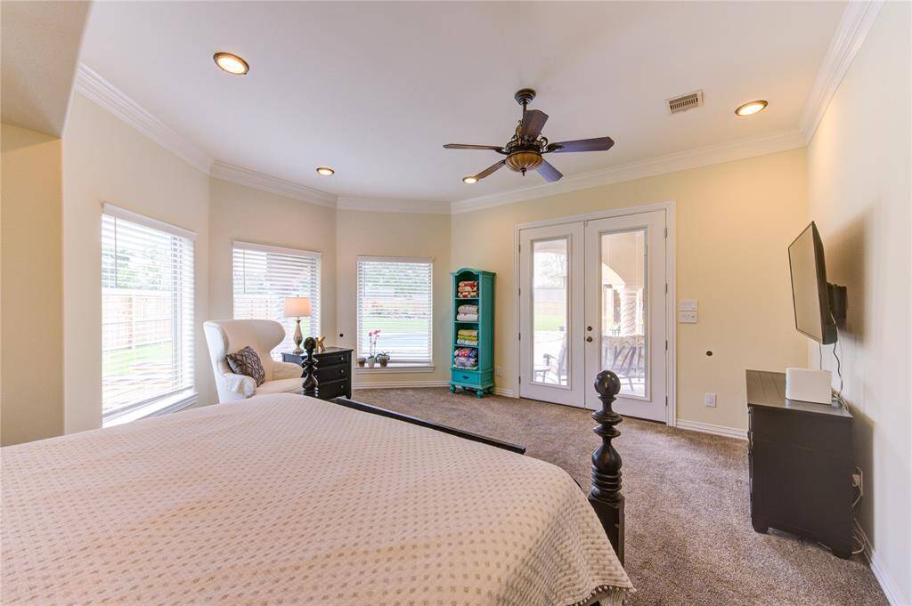 Double doors leading to veranda, pool area.