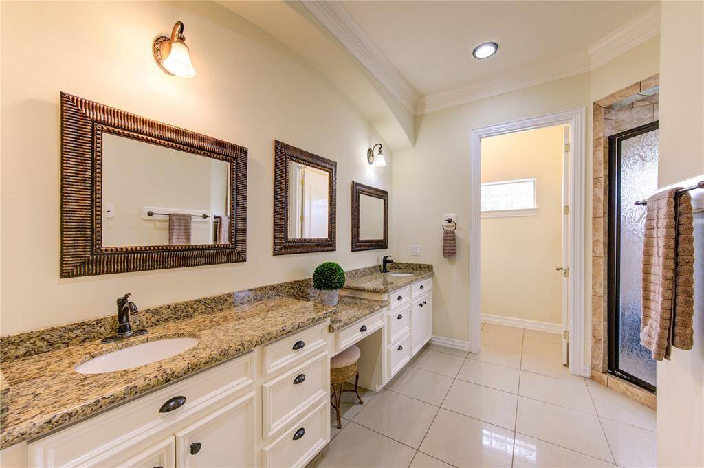 Double sinks, recessed lighting, premium granite and a vanity area.