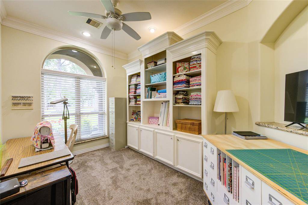 Dedicated study/office with build-in shelves and cabinets offers full view of front lawn.