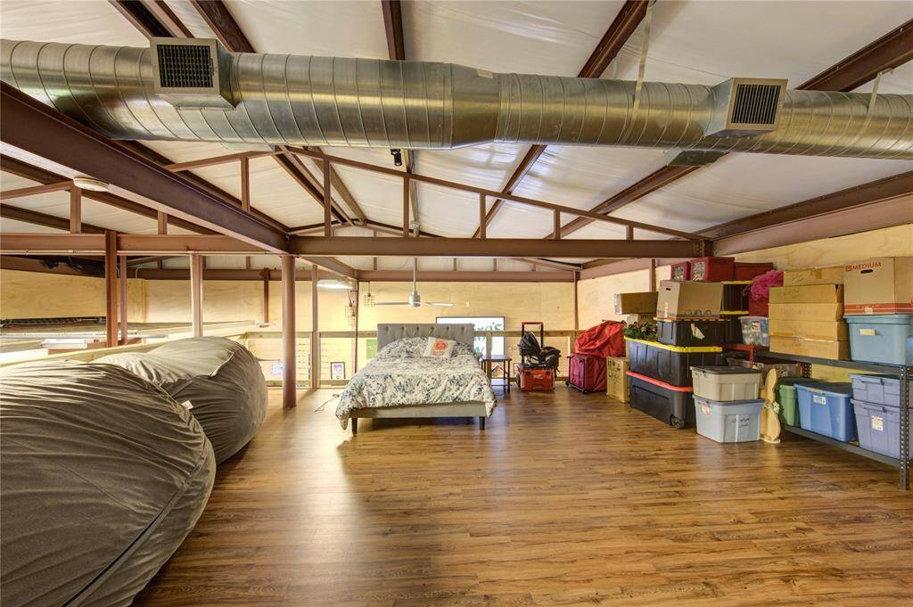 Another view of the 2nd floor loft area with cable surround and vinyl plank flooring. This is great for additional storage too!