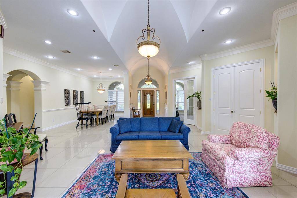 Each room perfectly designed with generous space and a free flow through the home. Double doors at right lead to secluded primary suite. Entire interior recently repainted including trim and crown moulding.