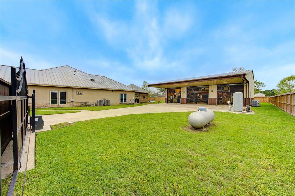 Automatic gated entrance to back yard and all the amazing amenities. In addition to the 6 car garage, there is a 2 car attached garage. Extra long driveway provides ample parking space with additional parking for a crowd beyond the security gate. Seller also had natural gas lines installed allowing the option of propane or gas to the house. Home hot water heater recently replaced. Home also comes with custom cut Christmas lights for the front of the home.