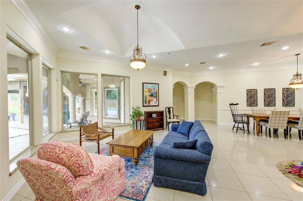 Living room offers a full view of the veranda and pool area.