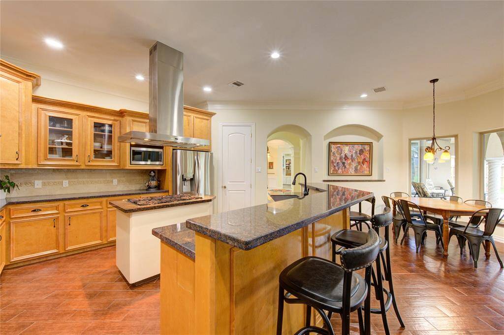 A Chef's dream kitchen with abundant cabinets, granite counters and convenient bar seating!