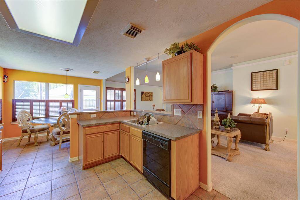 Open kitchen overlooks living room area.