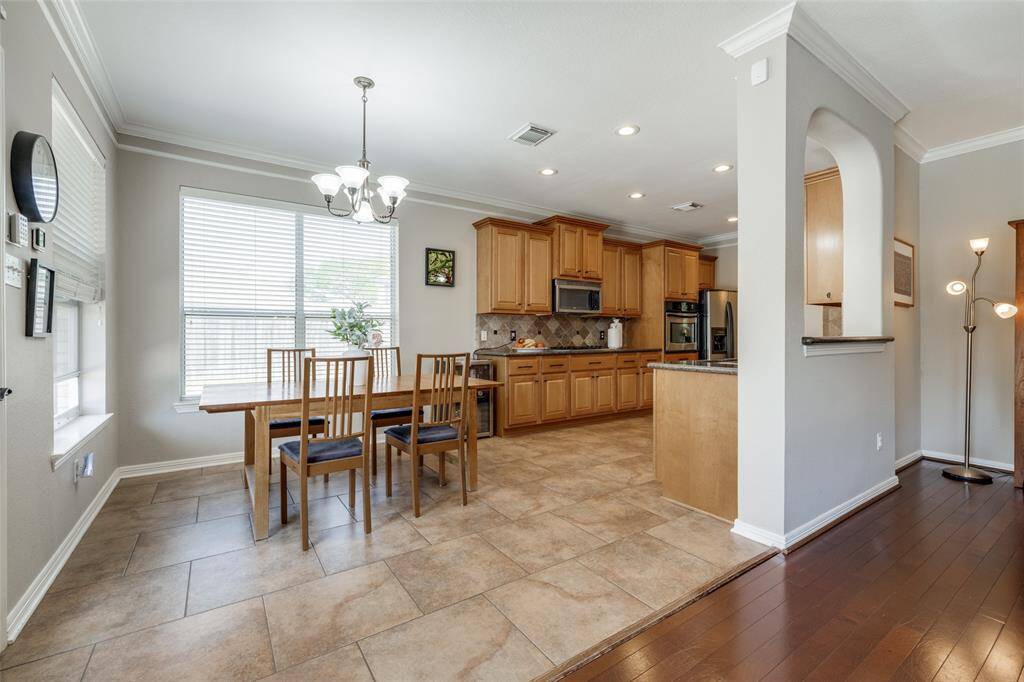 Breakfast Room, tiled floors, chandelier, wooden kitchen cupboards, gas cook top, SS refrigerator, recessed lighting, tiled back splash