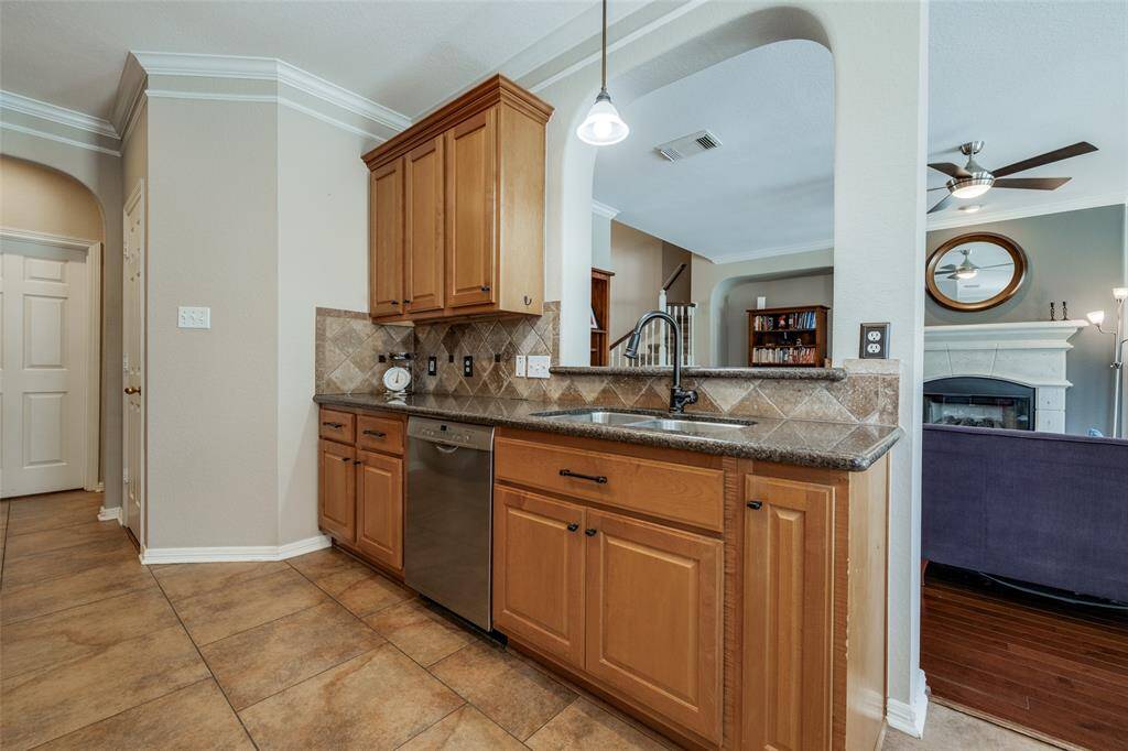 Kitchen with lots of cabinets, granite counter, SS appliances, tile floor