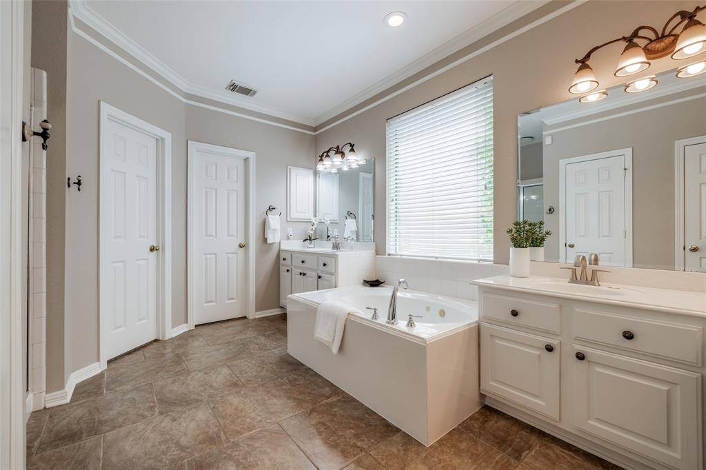 Large Primary bathroom with 2 closets, large bath, dual sinks, lots of natural light