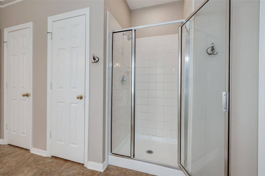 Large Primary bathroom with 2 closets, large bath, dual sinks, shower with silver surround