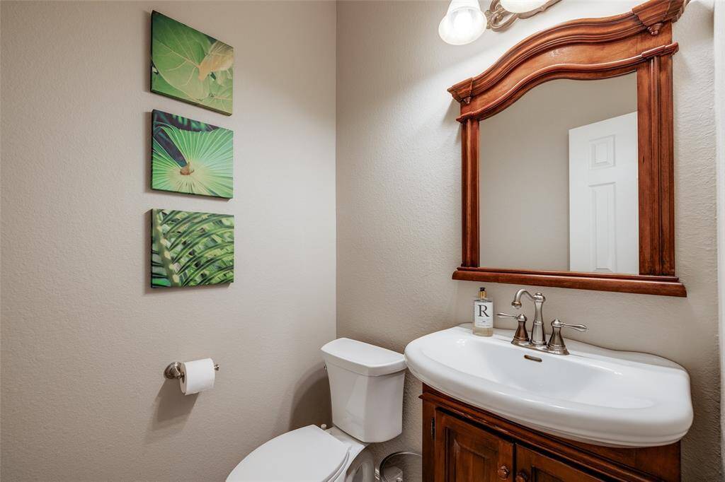 Half bath with wooden cabinet, mirror