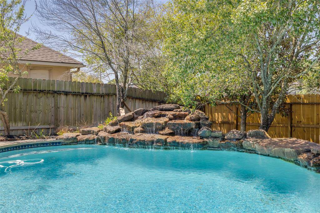 Fabulous quiet, private back yard with huge deep swimming pool with water falls, huge covered patio great for entertaining with family & friends and lots of extra deck space !