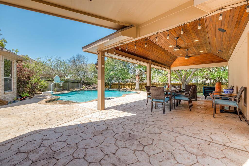 Huge covered wood clad ceiling patio - great for entertaining with family & friends, ceiling fans, half bath in the garage close by !