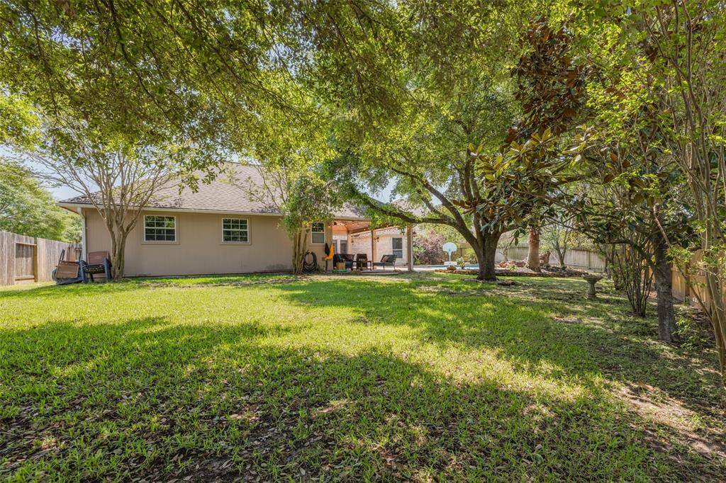 One of the largest lots in the neighborhood with mature trees - very peaceful back yard & door out to the bayou for chilldren to walk or cycle to nearby schools.
