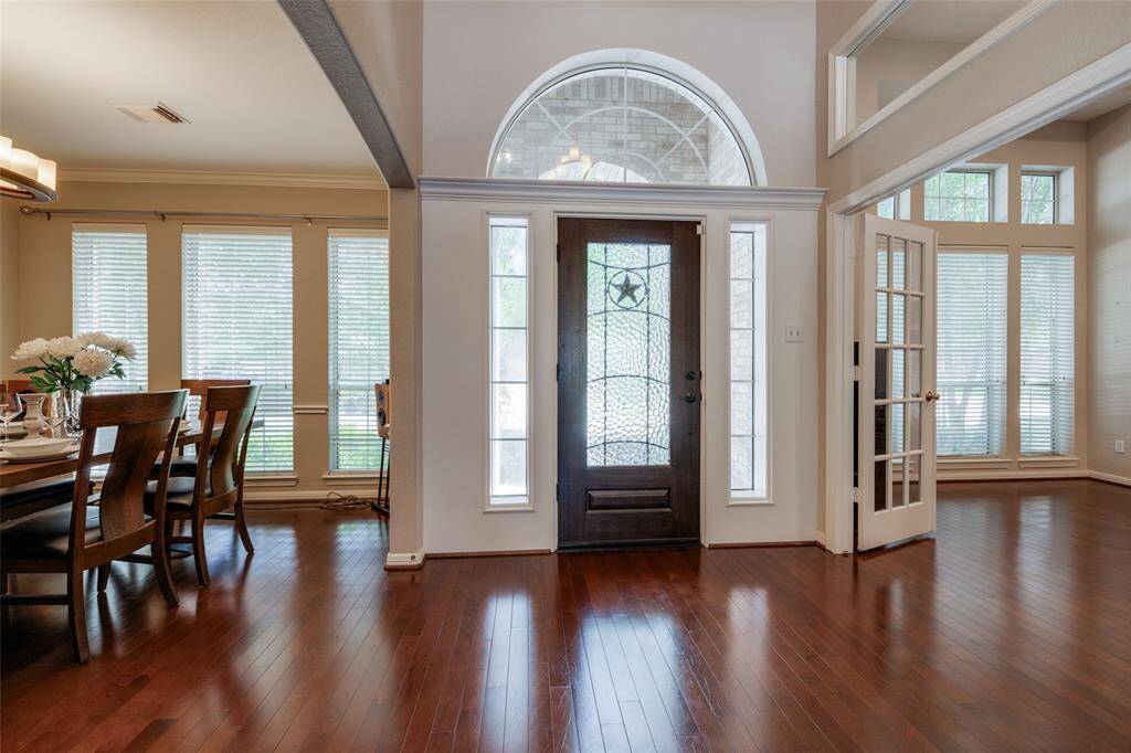 Enter through lead glass door with Texas Star, into a double height entry, large dining room to right and study with door to your right