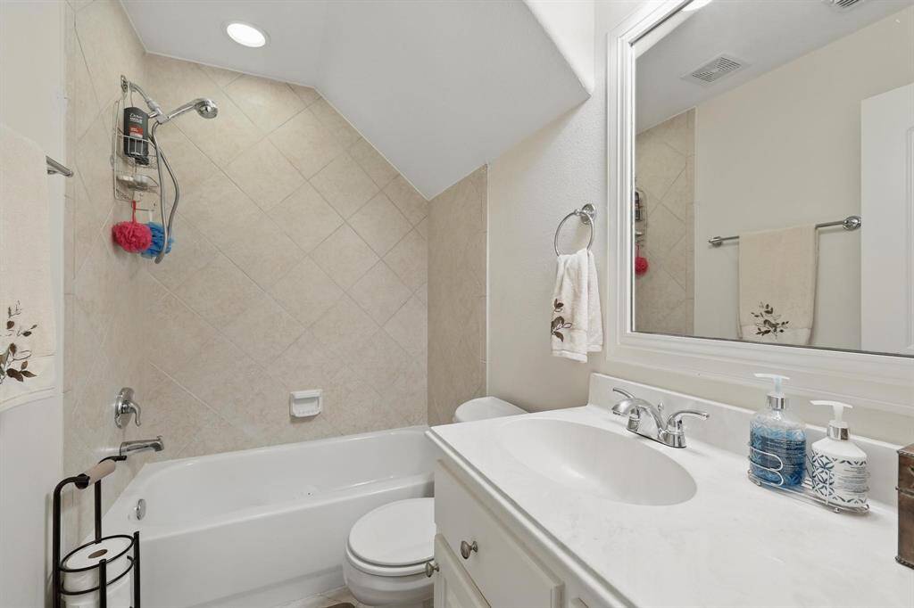 The second-floor full bath features beautiful tile work, combining style and functionality for a polished, modern look.