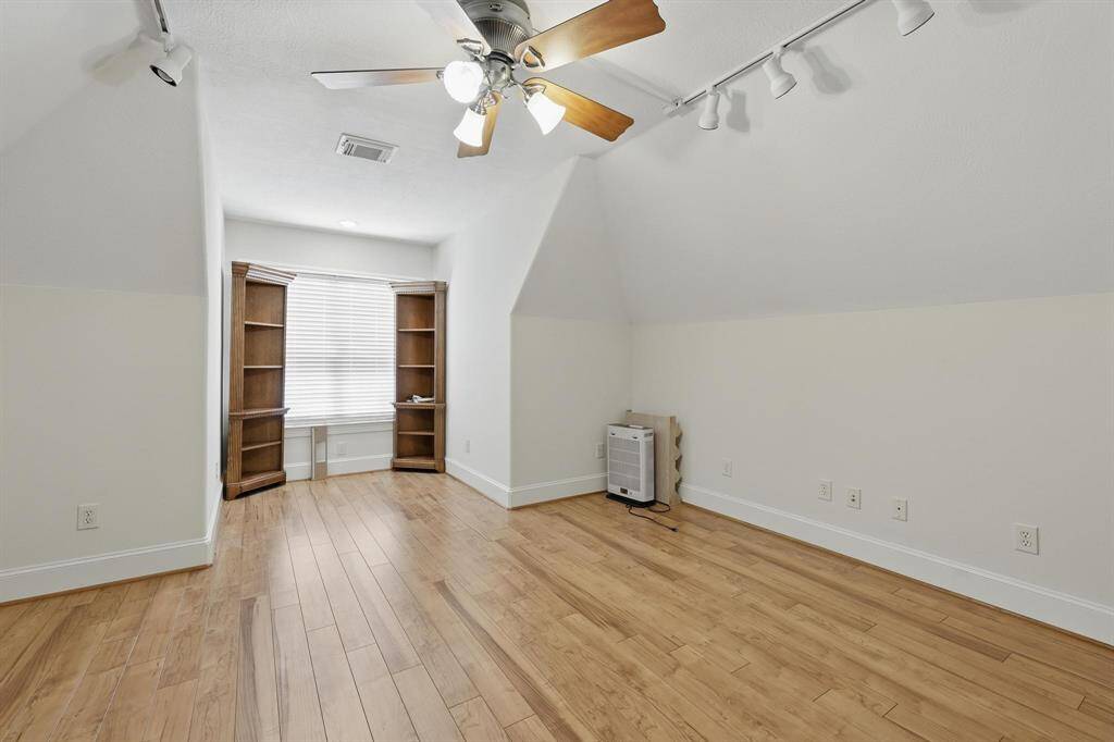 This spacious upstairs bonus room is perfect as a media room or game room, offering plenty of space to relax or entertain. It features directional lighting to create the ideal ambiance for any activity.