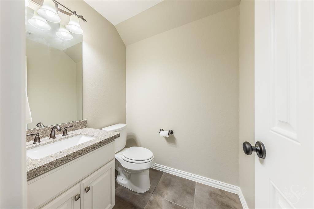 Half bath, located upstairs by the built-in study nook.