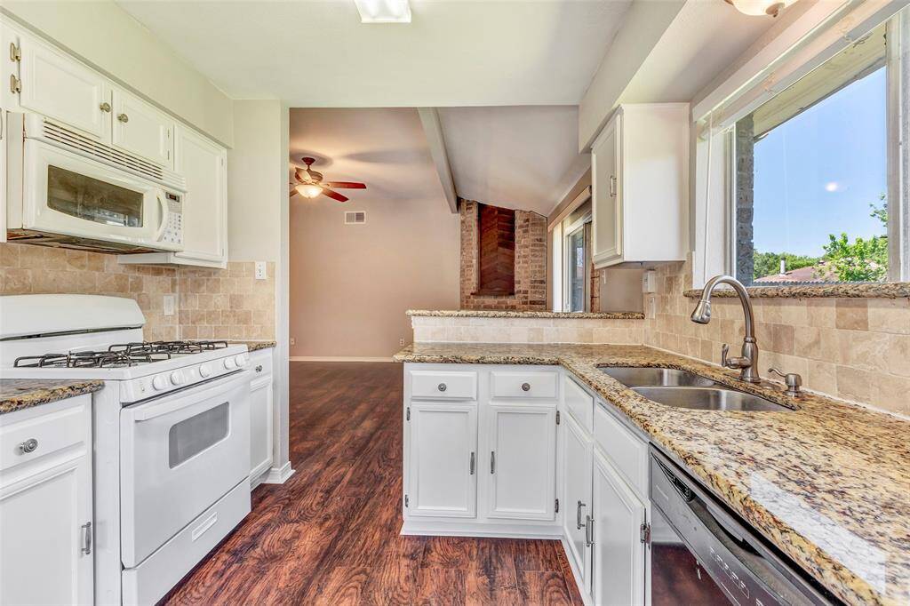 From this vantage point in the kitchen, the living room is visible in the background, highlighting the home's semi-open layout."
