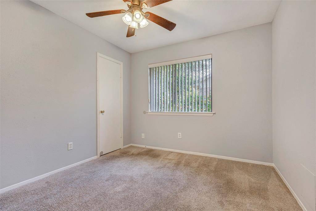 This versatile secondary bedroom features a walk-in closet and plush carpeted floors, offering a comfortable space that you can personalize to suit your style and needs.