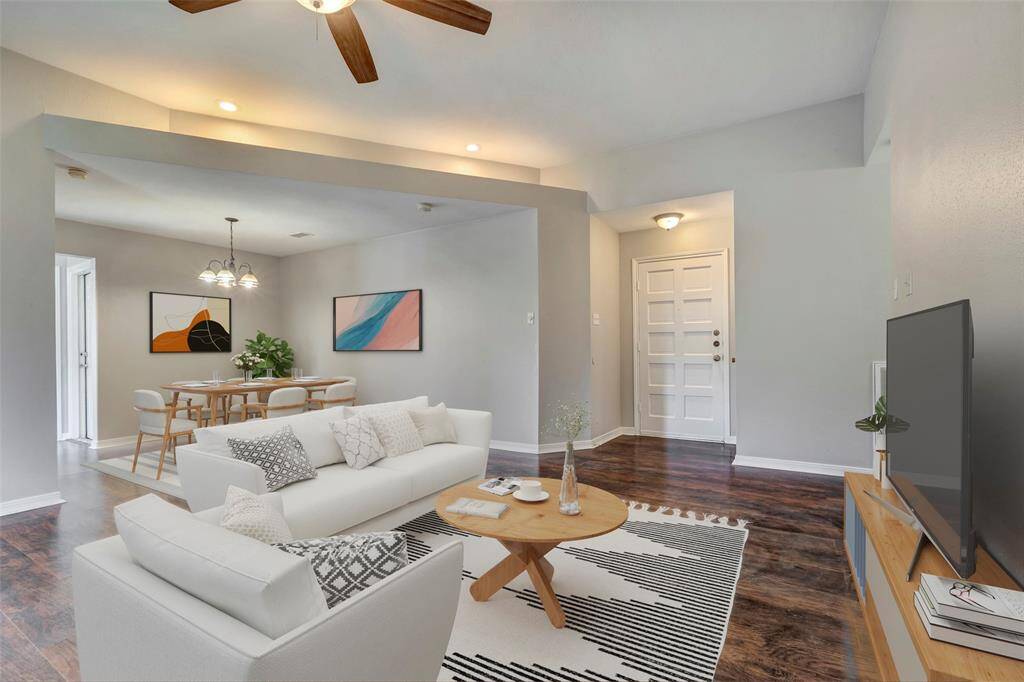 This view highlights the open layout seamlessly connecting the living room and dining area, perfect for both everyday living and entertaining. (Virtually Staged)