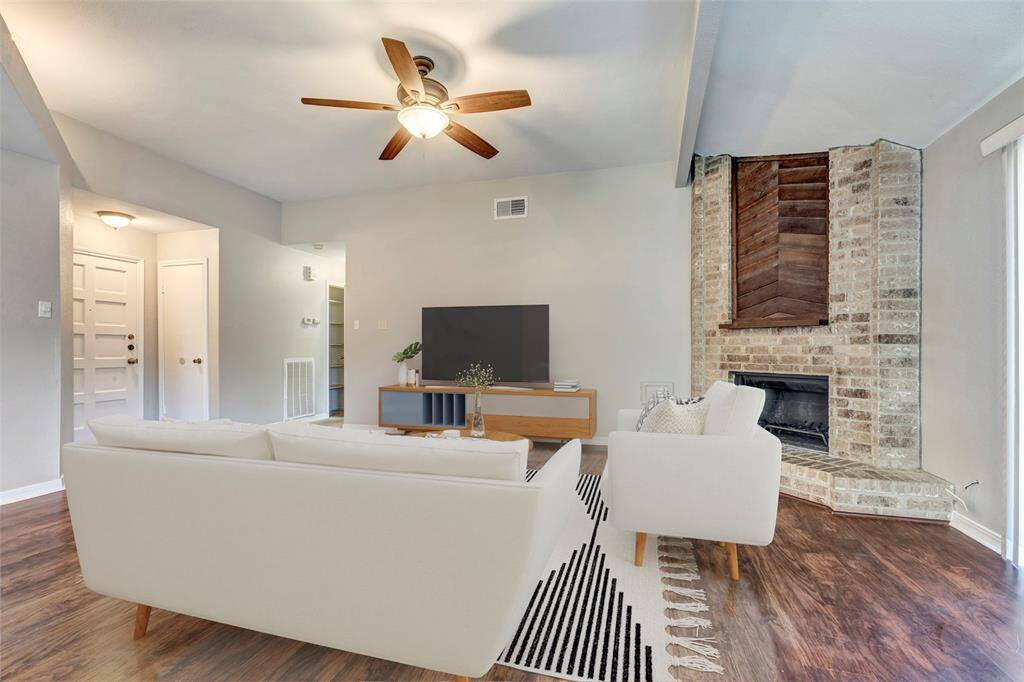 A welcoming view of the main door and foyer from the living room, showcasing an open and inviting entryway. (Virtually Staged)