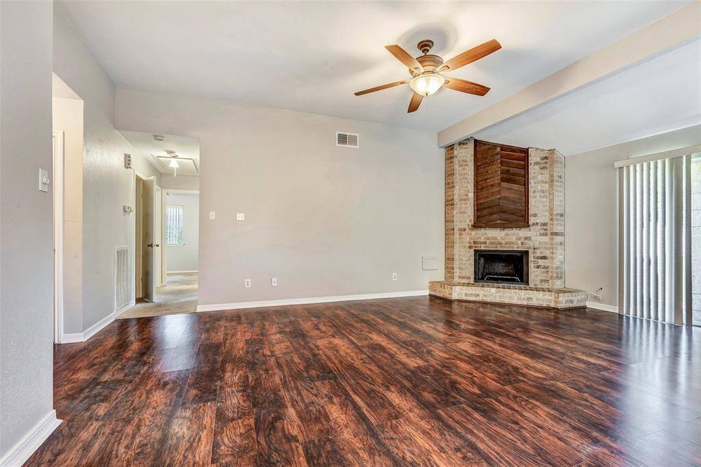 A view of the living room from the dining area, with a hallway to the left that leads to additional rooms—offering a smooth and functional flow throughout the home.