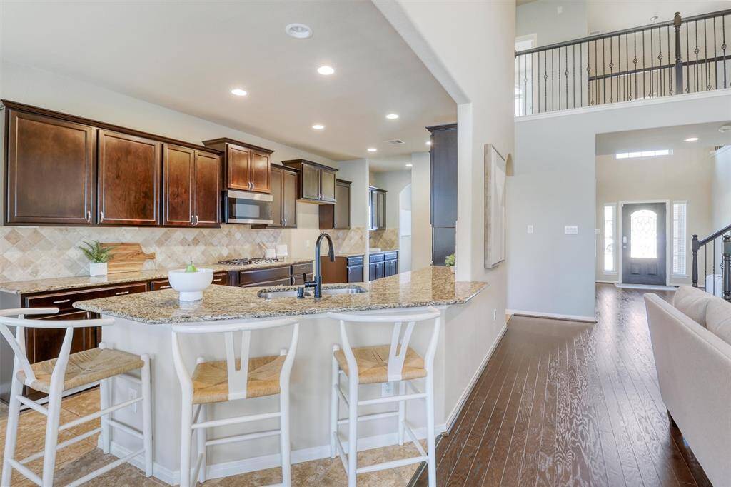 The expansive kitchen flows effortlessly into the family room with clear sightlines to the foyer, creating a truly open-concept layout that’s perfect for both entertaining and everyday living.