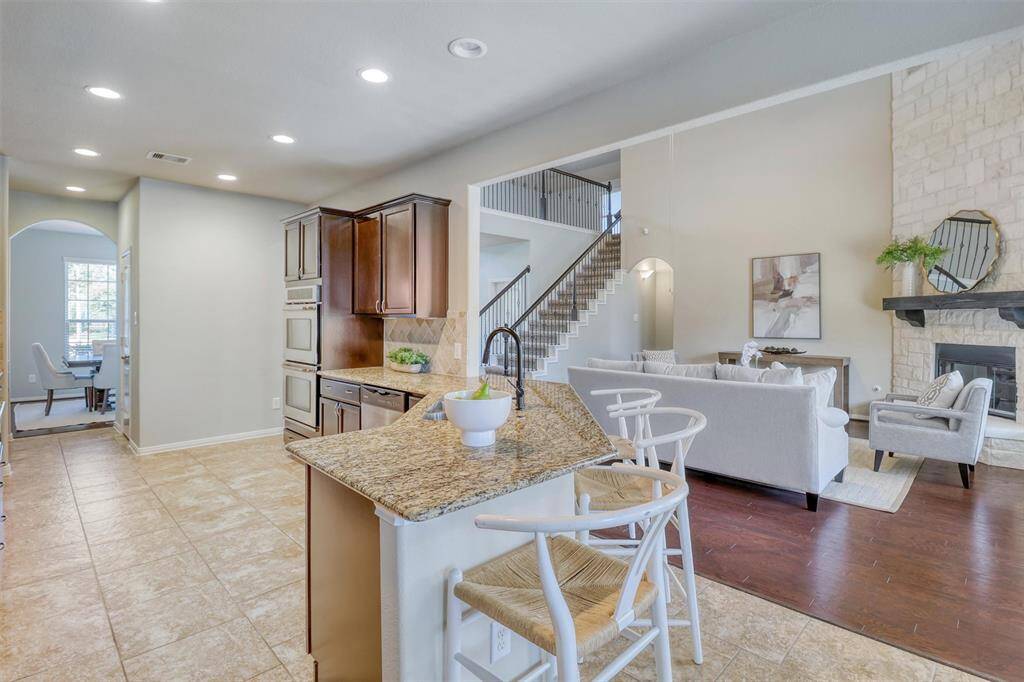 An expansive peninsula with breakfast bar seating anchors the kitchen and provides the perfect perch for casual dining or entertaining—all while maintaining clear sightlines to the family room and fireplace.