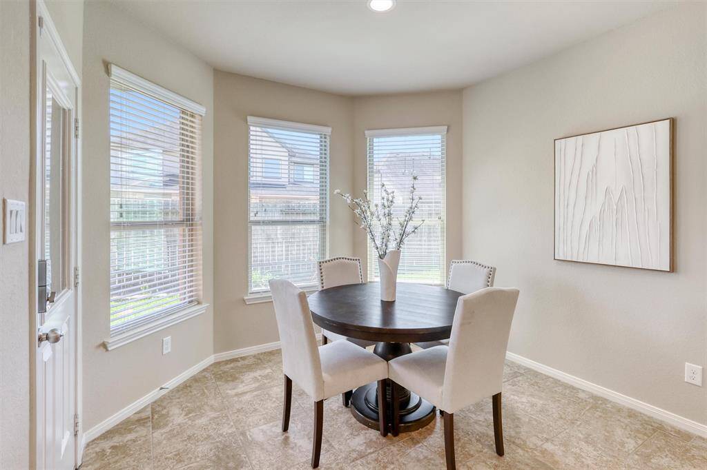 Whether you're sipping coffee or helping with homework, the cozy breakfast nook is the ideal casual dining space with a backyard view and direct patio access.