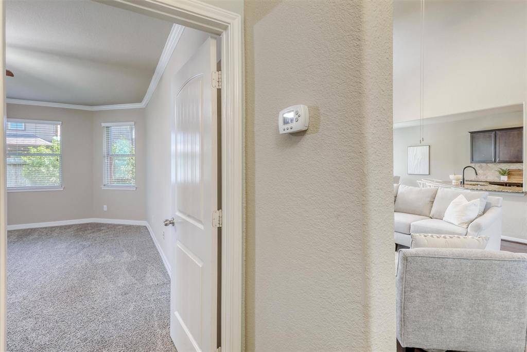 Just off the main living area, a private hallway leads to the serene first-floor primary suite—seamlessly blending comfort and accessibility into the home’s thoughtful layout.