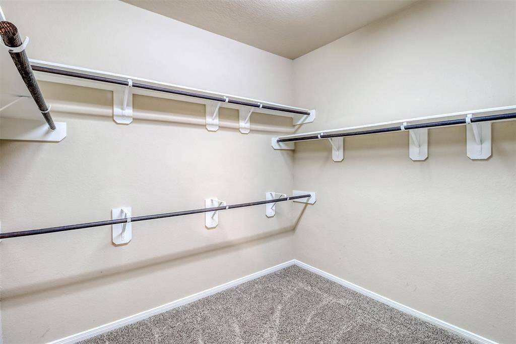 Keep everything organized with ease in the oversized walk-in closet, complete with built-in shelving and extensive hanging space.