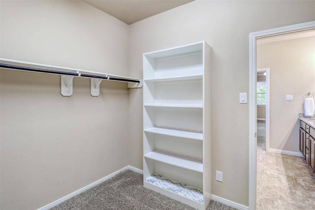 With direct access to the bath and thoughtful design throughout, this walk-in closet is more than just storage—it’s a daily convenience that makes all the difference.