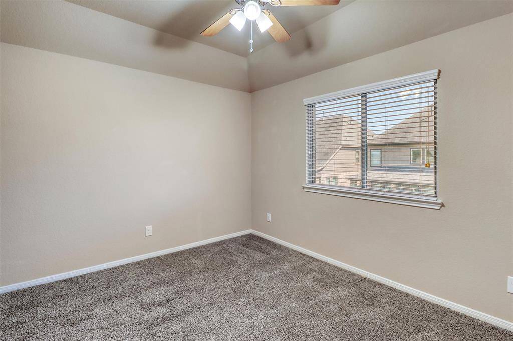 Tucked upstairs for added privacy, this spacious guest retreat features plush carpeting, soft neutral paint, a cooling ceiling fan, and plenty of natural light.