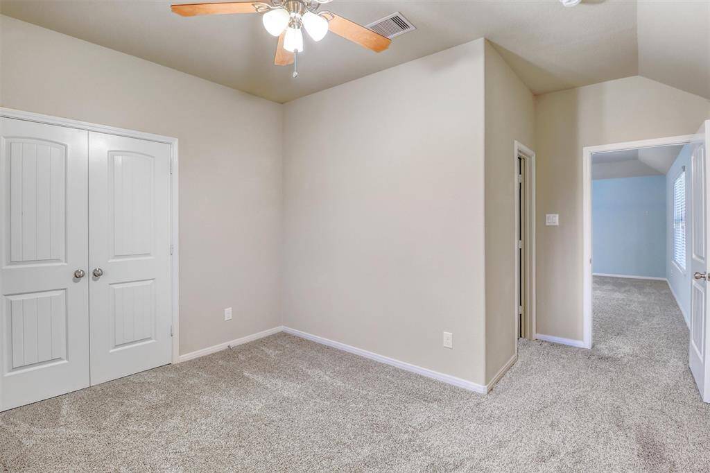 A double-door closet provides generous storage, while direct access to a private bath makes this an ideal space for overnight visitors or multigenerational living.