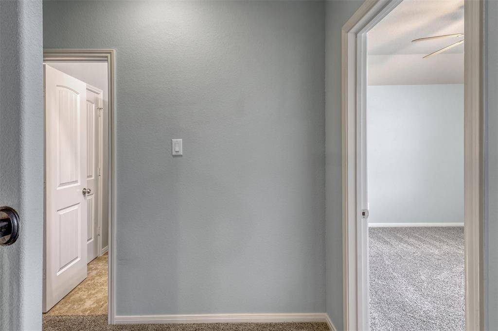 A charming hallway leads to the additional guest bedroom and shared bathroom, creating a cozy and private wing upstairs.