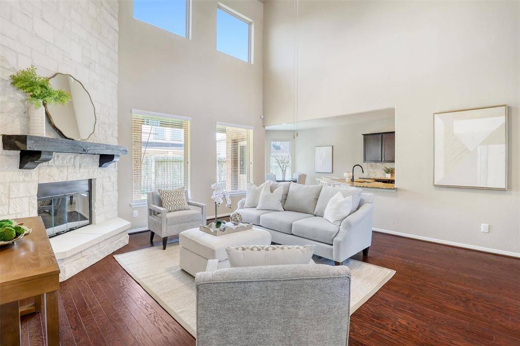 With oversized windows flooding the room with natural light, this open-concept family room effortlessly connects to the kitchen and casual dining area—perfect for both daily living and entertaining.