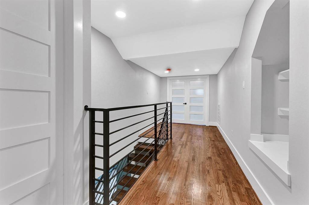 Take a look at the beautifully designed upstairs hallway, featuring custom built-in shelving that adds both charm and functionality—perfect for displaying décor, books, or extra storage!