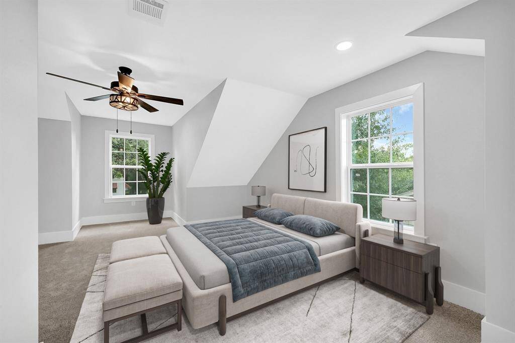 This spacious bedroom features multiple windows that let in plenty of natural light, cozy carpet underfoot, and a ceiling fan for added comfort, making it a perfect place to relax. *Virtually Staged*