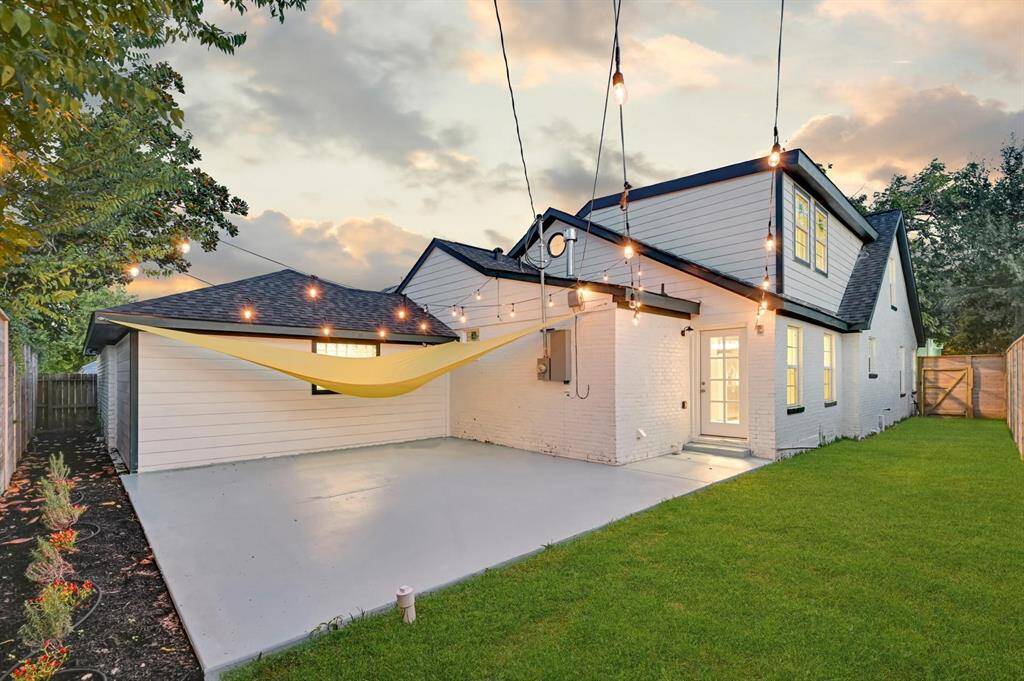 Step into the spacious fenced backyard featuring a vibrant green lawn and a large patio—perfect for outdoor entertaining, relaxing evenings, and family fun!