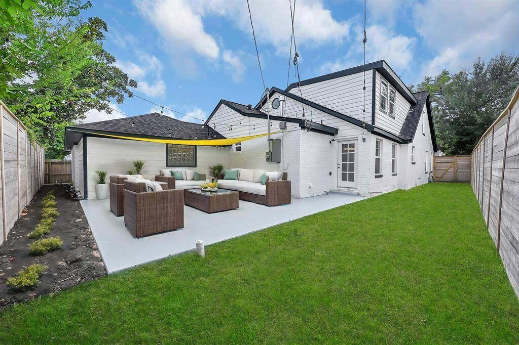 Step into the spacious fenced backyard featuring a vibrant green lawn and a large patio—perfect for outdoor entertaining, relaxing evenings, and family fun! *Virtually Staged*
